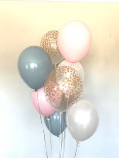 a bunch of balloons that are in the shape of stars and polka dots on them