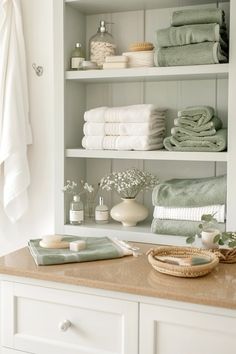 the shelves in this bathroom are filled with folded towels and other bath accessories, such as soaps