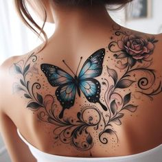 the back of a woman's shoulder with a butterfly and roses tattoo on it