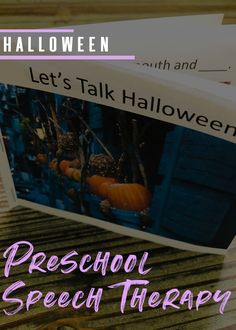 an open book sitting on top of a wooden table with pumpkins in the background