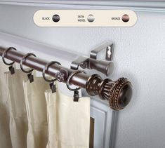 the curtain rod is attached to the side of a door with two rings on it