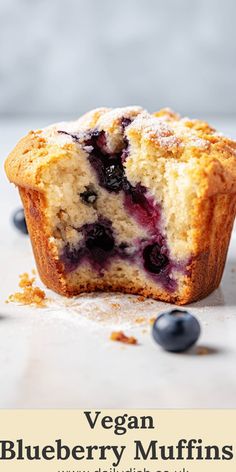 blueberry muffins with powdered sugar and fresh blueberries on the side