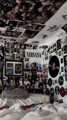 a bedroom with many pictures on the wall