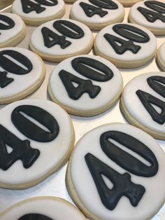 decorated cookies with black and white frosting are arranged in the shape of letters that spell forty