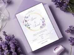 a wedding card with flowers on it next to some purple and white ribbons, scissors and ribbon