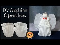 cupcake liner angel with red bow on it's head and two white cups in front