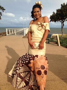 a woman is standing next to an animal made out of cloths and fabric material