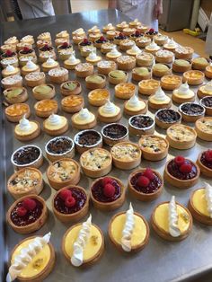 many small pies are lined up on a table