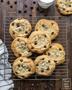 chocolate chip cookies on a cooling rack next to a glass of milk