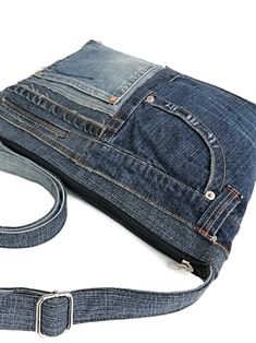 a bag made out of jeans with a belt around it's waist and zippered closures