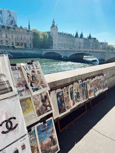 many posters are on display near the water