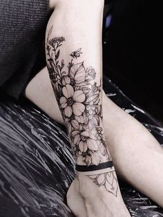 a woman's leg with flowers on it