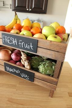 a wooden crate filled with fresh fruits and vegetables