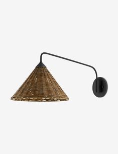 a wall light that is made out of wicker and black metal with a white background