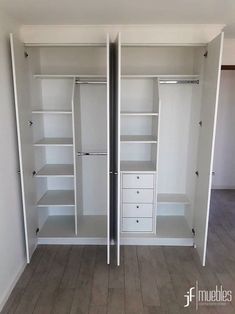 an empty closet with white shelves and drawers