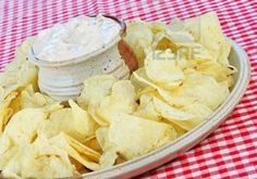 crock pot creamy onion dip with chips on the side and red checkered tablecloth