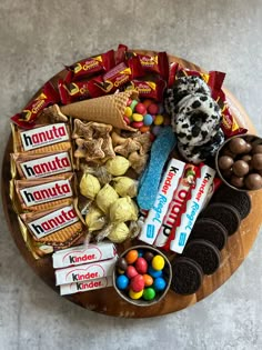 a wooden plate topped with lots of candy and candies