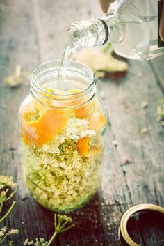 someone pouring water into a jar filled with food