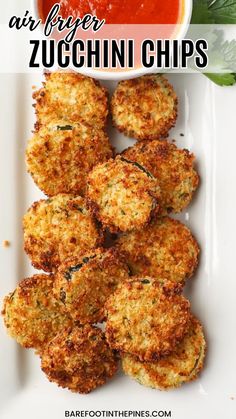 fried zucchini chips on a white plate with marinara sauce