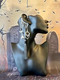 This enchanting Victorian vampire ear cuff is sure to make a statement and bring out your inner magic! Silver ear cuff features an onyx cameo pendant with bat, black crystals, bat charms, and black & white fabric tassel all hanging from silver plated chains. This ear cuff is perfect for adorning pierced and non-pierced ears!  Your jewelry is always wrapped in a jewelry bag and ready to be the perfect unique gift for yourself or someone you love! 🖤 Wing Headpiece, Whimsigoth Jewelry, Victorian Vampire, Vampire Costume, Wrap Earrings, Bat Wing, Silver Ear Cuff, Black And White Fabric, Cameo Pendant