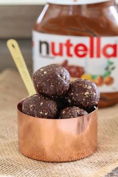 chocolate peanut butter balls in a copper bowl next to nutella