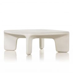 a white coffee table sitting on top of a white floor