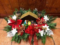 a christmas wreath with poinsettis and other decorations