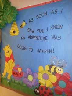 a winnie the pooh bulletin board with flowers, bees and honeycombs on it