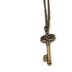 This key necklace created by Jewelry By Luet and Co is made of:  a brass skeleton key, brass:  chain, lobster claw clasp and findings.  This necklace measures 18 1/4 inches in length.WE OFFER FREE STANDARD SHIPPING WITHIN THE UNITED STATES.All of our jewelry is unique and custom designed. We would love to assist you with any custom orders or needs for special occasions!We appreciate you shopping with Jewelry By and Luet and Co and hope you will do so often!See more items from my shop: http://www Vintage Brass Necklaces With Two Keys, Metal Key Necklace Perfect As Gift, Vintage Gold Jewelry With Keys, Steampunk Jewelry With Keys For Gifts, Antique Gold Necklaces With Two Keys, Bronze Brass Necklace With Keys, Gold Brass Necklace With Keys, Vintage Gold Necklaces With Keys, Vintage Gold Key Necklace