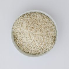 a white bowl filled with rice on top of a table