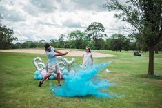 a man and woman playing golf with blue powder