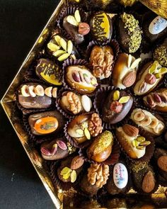 a box filled with lots of different types of donuts on top of a table