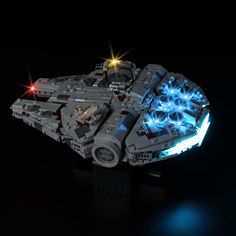 a lego star wars millennium falcon is shown in the dark with its lights turned on