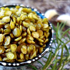 a bowl filled with nuts sitting on top of a counter