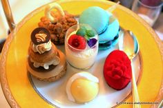 an assortment of desserts on a yellow plate