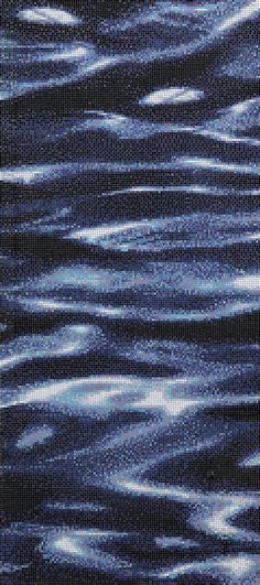 an image of water that is very dark blue and has some white dots on it