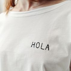 Hola Embroidery trendy T-Shirt Unique Design Limited Edition White Women's Trend T-Shirt Trend T-Shirt Unique, Hola, Embroidery Slogan Tshirt, Gift, Christmas, Birthday Gift, Mother's Day Gift, Valentine Gift HOLA Embroidered Minimal Slogan, Limited Edition, Designer White T-Shirt Loose T-shirt One Size %100 cotton Bottom: 56cm Length: 48cm Wash 30 degrees, No Tumble Dry, Iron Reverse Basic Relaxed Fit Top With Custom Embroidery, Basic Cotton Tops With Custom Embroidery And Relaxed Fit, White Casual Tops With Custom Embroidery, White Casual Top With Custom Embroidery, White Relaxed Fit T-shirt With Letter Embroidery, Summer Cotton Tops With Embroidered Logo, Summer Cotton Top With Embroidered Logo, White Crew Neck Top With Embroidered Graphics, White Embroidered Crew Neck Top