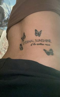 a woman with a tattoo on her stomach that says eternal sunshine line and two butterflies