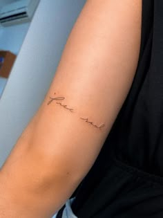 a woman's arm with a tattoo that says love in cursive writing