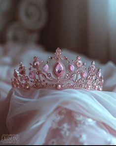 a pink tiara sitting on top of a bed