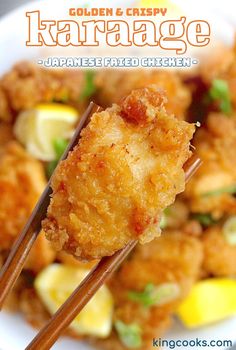 a close up of food with chopsticks in it and the words golden & crispy japanese fried chicken