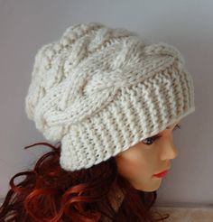 a mannequin head wearing a white knitted hat