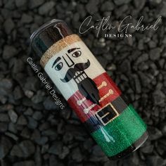 a close up of a canister with a face painted on it's side