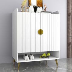 a white cabinet with some shoes on it