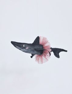 an ornament shaped like a whale with a pink tutu skirt hanging from it's tail