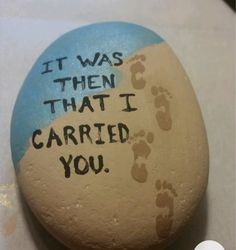 a painted rock that says it was then that i carried you with footprints on it