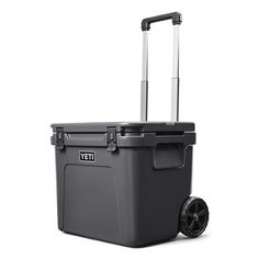 a large gray cooler with wheels on a white background and the words yet written in black