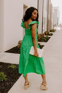 - This sweet dress is perfect for a sunny day! - Lightweight, green hued material with a lined bust - A scoop neckline - A bust with gathered detail - Flutter sleeves with elastic shoulders - A smocked upper back - A relaxed silhouette that ends in a straight midi length hemline Green Flutter Sleeve Summer Dress, Green Flutter Sleeve Dress For Vacation, Green Ruched Midi Dress With Square Neck, Green Flutter Sleeve Beach Midi Dress, Green Ruched Midi Dress For Beach, Green Midi Dress With Flutter Sleeves, Green Ruffled Sundress Midi Dress, Green Flutter Sleeve Casual Midi Dress, Green Midi Dress With Smocked Back For Day Out