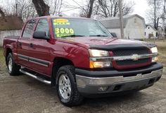 a red pick up truck with a for sale sign on it