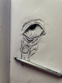 a pencil drawing of an eye looking through the hole in a piece of paper with writing on it